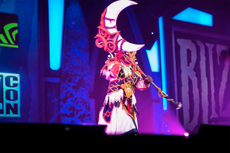 A World of Warcraft Druid holds up their artifact weapon, the scythe of Elune.
